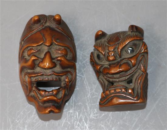 A Japanese Meiji carved wood Noh mask netsuke of Hannya and another similar